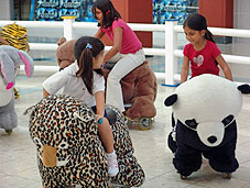 Kids riding on Zippy Rides animals. Pembroke Lakes Mall, Florida